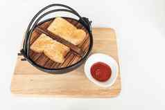 烤面包黑色的铁碗番茄酱汁木托盘
