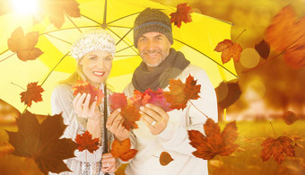 复合图像肖像夫妇持有秋天叶子站黄色的伞