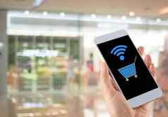 模糊散景购物购物中心手智能手机购物车无线网络