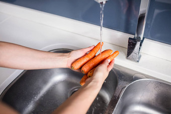 女人洗胡萝卜厨房水槽
