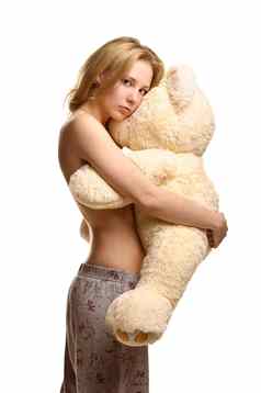 女孩睡衣裤子拥抱巨大的豪华的熊
