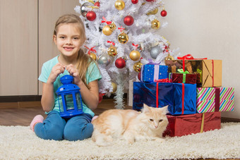 七年女孩坐在猫圣诞节树礼物微笑幸福的