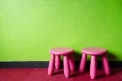 孩子粉红色的椅子绿色房间