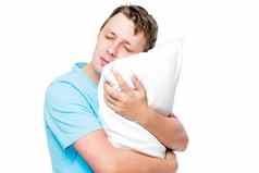 睡觉男人。拥抱软枕头白色背景