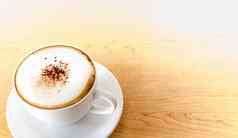 杯热咖啡卡布奇诺咖啡木表格背景
