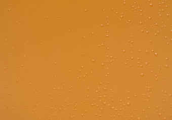 宏拍摄橙色冒泡的泡沫钙维生素冒泡的平板电脑透明的玻璃橙色颜色纹理背景