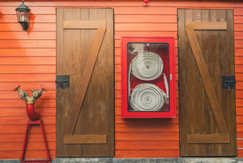 火软管红色的内阁挂橙色木墙火紧急设备盒子安全安全系统火安全泵洪水系统消防系统管道火保护