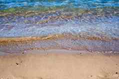 透明的海波卷黄色的清洁沙子