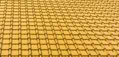现代黄色的黄金光滑的屋顶瓷砖纹理背景