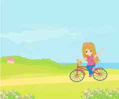 快乐开车自行车可爱的微笑年轻的女孩