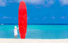 可爱的女孩红色的大冲浪板热带假期