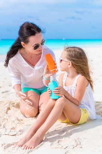 有爱心的妈妈应用太阳奶油孩子鼻子白色海滩概念保护<strong>紫外线辐射</strong>