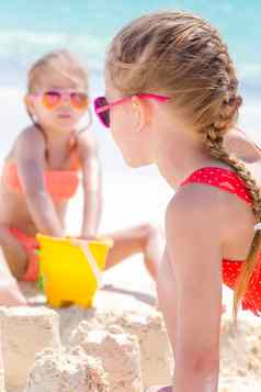 可爱的女孩夏天假期孩子们玩海滩玩具白色海滩