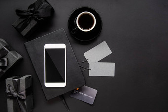 黑色的智能手机价格标签咖啡礼物前视图黑色的背景