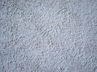 水泥石膏皮毛外套街石膏墙纹理大凸起白色空背景完成建筑外墙