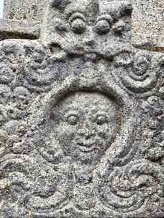 古老的石头雕刻人类脸雕塑发现寺庙墙kapaleeshwarar寺庙泰米尔Nadu石头墙纹理古老的寺庙