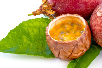 maracuja减少一半小玻璃容器皮水果叶白色背景激情水果黄色的水果汁种子