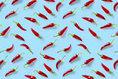 有创意的背景使红色的辣椒辣椒蓝色的背景最小的食物背景红色的热辣椒辣椒背景