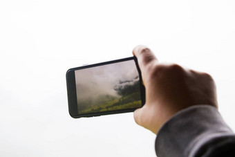 持有智能手机<strong>照片视频</strong>自然景观拍摄视频电话相机