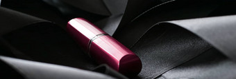 粉红色的口红黑色的丝绸背景奢侈品化妆漂亮的东西或人