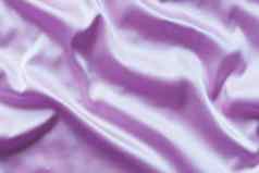 光滑的优雅的淡紫色丝绸软折叠背景