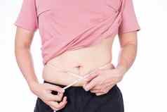 胖乎乎的男人。测量腰白色测量磁带孤立的白色背景饮食生活方式重量损失胃肌肉健康的概念