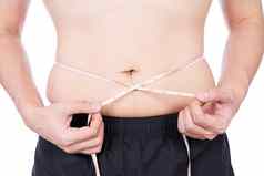 胖乎乎的男人。测量腰白色测量磁带孤立的白色背景饮食生活方式重量损失胃肌肉健康的概念