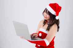 美丽的年轻的亚洲女人圣诞老人工作移动PC第一版
