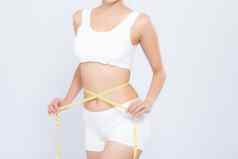 亚洲女人饮食苗条的测量腰重量隔离