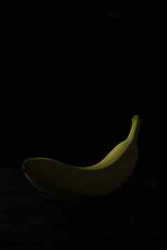 单黄色的香蕉黑色的木背景