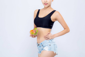 特写镜头身体美丽的亚洲女人持有沙拉蔬菜食物