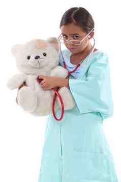 女孩穿着护士持有泰迪熊