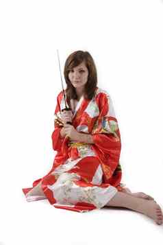 法国年轻的女孩艺妓红色的丝绸和服日本剑