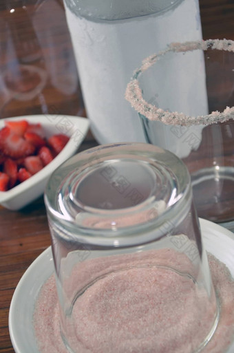 粉红色的糖有框的玻璃草莓鸡尾酒