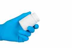手蓝色的橡胶手套持有Jar药片孤立的白色