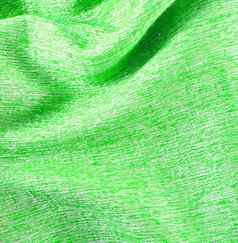绿色皱巴巴的丝绸织物变形背景