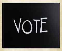 词“投票”手写的白色粉笔黑板上