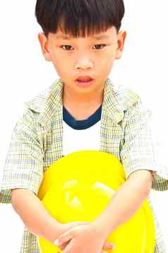 亚洲婴儿男孩黄色的头盔持有锤孤立的whi
