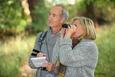 夫妇退休人员观察野生动物双筒望远镜森林