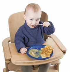 年轻的孩子吃高椅子