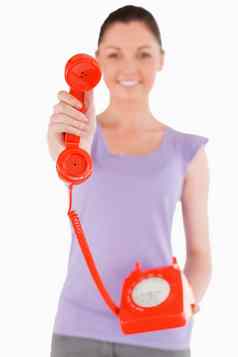 有吸引力的女人持有红色的电话站
