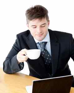 有魅力的businesman喝咖啡移动PC