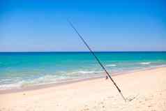 钓鱼杆白色沙子热带海滩葡萄牙