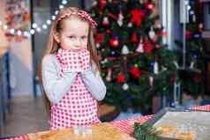 可爱的女孩穿连指手套烘焙圣诞节姜饼饼干