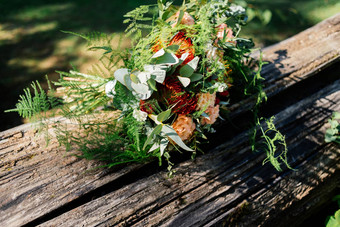 郁郁葱葱的婚礼花束灰色的木板凳上水