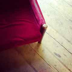 古董红色的天鹅绒扶手椅木地板上