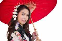 美丽的年轻的亚洲女人穿传统的日本和服红色的伞孤立的白色背景