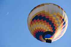 色彩斑斓的热空气气球飞行月亮