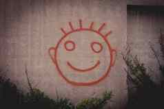 涂鸦绘画红色的快乐笑脸脸混凝土墙