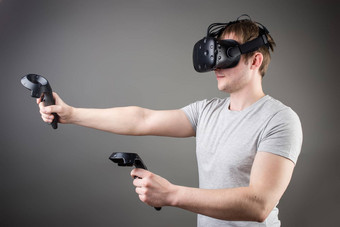 技术游戏娱乐人概念快乐年轻的男人。虚拟现实耳机眼镜控制器手柄玩赛车视频游戏首页